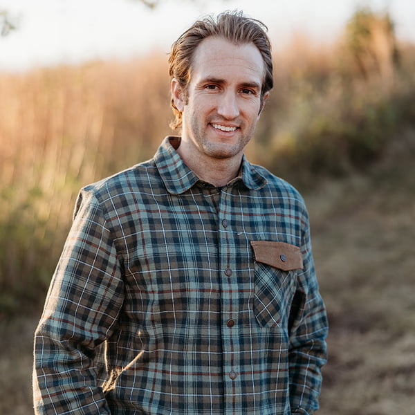 Dr. David Streitz standing in a field of tall grass on a clear day
