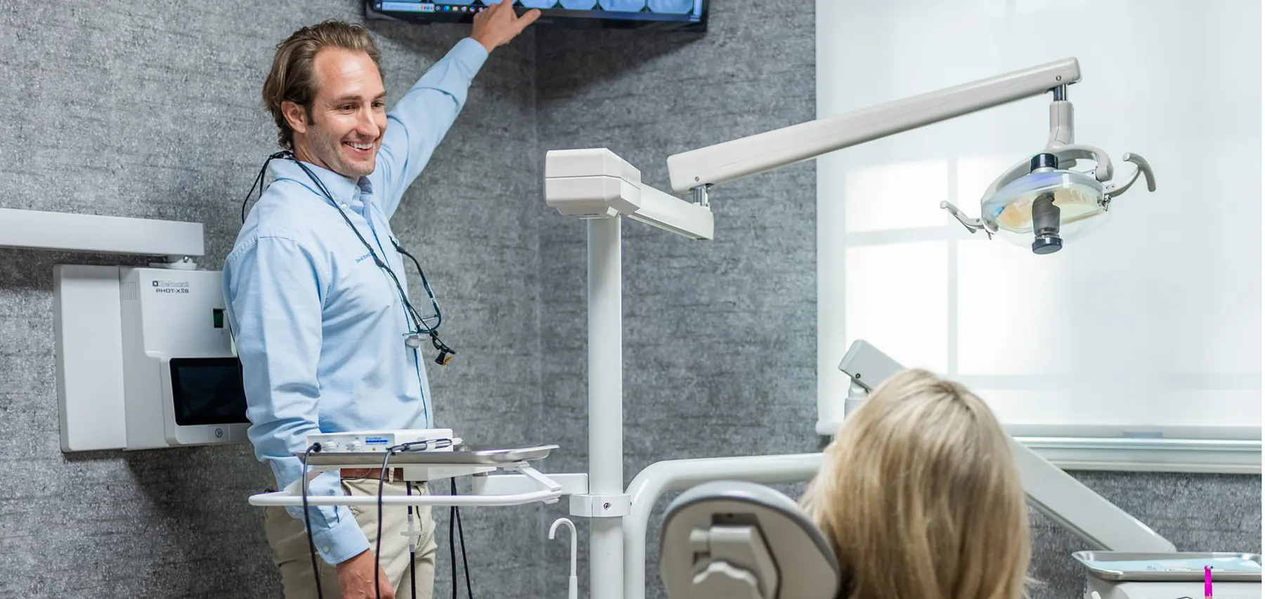 A receptionist at Streitz Dental Arts welcoming a new patient